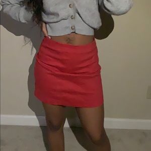 A orangish red mini skirt